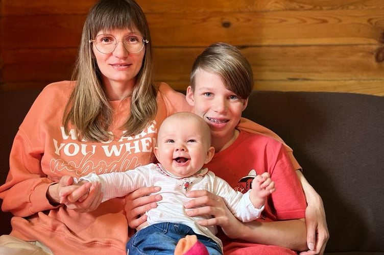 Mum Olha, six-month-old Maria and brother Illia, 11