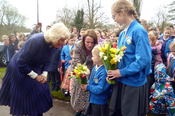 The Duchess of Cornwall receives flowers from Chawton CE Primary School pupils Cecily Hook, four, and Holly Bayliss, 11, as she visits Jane Austen’s House in Chawton on April 6th 2022.