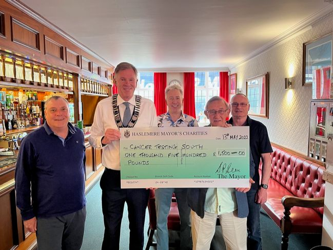 Town mayor Cllr Simon Dear presents the cheque to Cancer Testing South