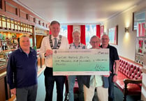 Haslemere mayor Councillor Simon Dear presents charity cheques