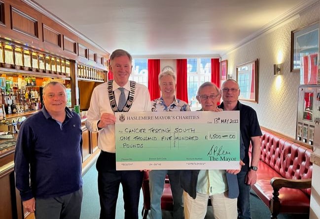 Town mayor Cllr Simon Dear presents the cheque to Cancer Testing South