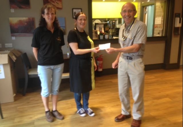 Paul Mills passing a cheque to Haslewey manager Magdalena Psonka