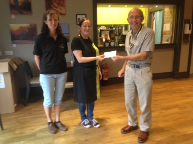 Paul Mills passing a cheque to Haslewey manager Magdalena Psonka