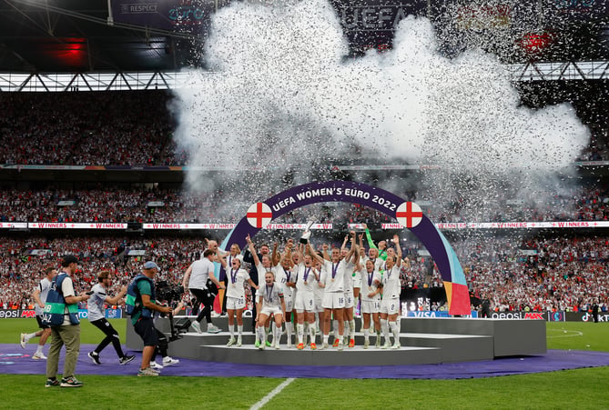 LONDON, ENGLAND - JULY 31: Leah Williamson and Millie Bright of England lift the UEFA Womenâs EURO 2022 Trophy after their sides victory during the UEFA Women's Euro 2022 final match between England and Germany at Wembley Stadium on July 31, 2022 in London, England. (Photo by Lynne Cameron - The FA/The FA via Getty Images)