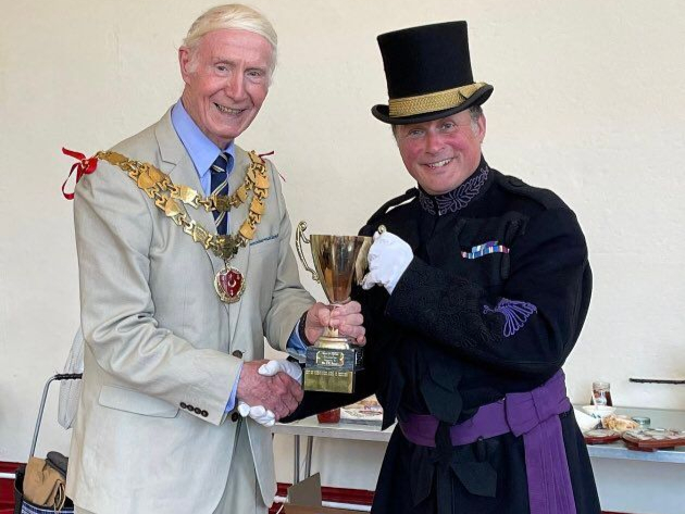 Christian receives his trophy from Cllr Russell. Photo by Sophia Lewis-Fry