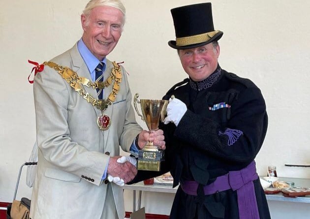 Christian receives his trophy from Cllr Russell. Photo by Sophia Lewis-Fry