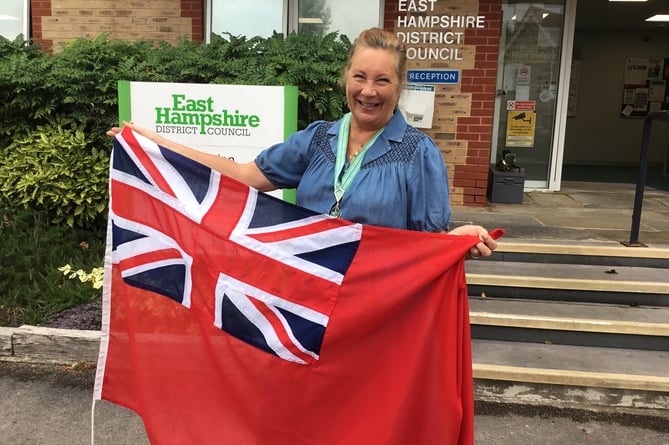 Cllr Ingrid Thomas with the Red Ensign.