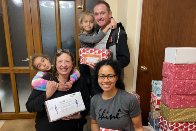 Lisa Hillan, left, Igor and Biola Ameri and their daughters pack Christmas boxes heading to Ukraine from Alton, November 2022.