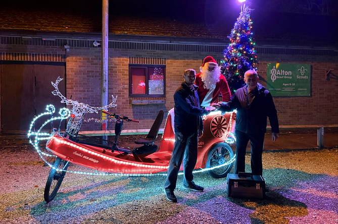Pictured outside the 8th Alton Scouts headquarters are Santa on his eco sleigh, David Russell from Alton Round Table and Michael Loxley from Alton Men’s Shed with its new toolbox, November 2022.