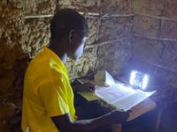 Volunteer from Liphook helps Kenyan children do their homework