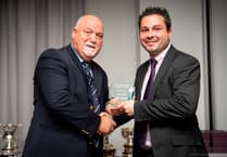 England player Mike Gatting presents Rowledge wicketkeeper with 'golden gloves' award