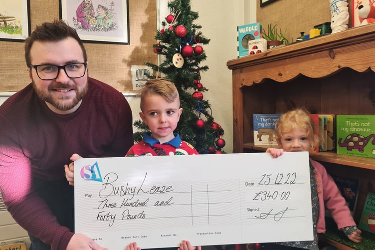 David Yeates, senior partner at accountants Styles & Associates, presents a cheque for £340 to children at Bushy Leaze Children and Families Centre in Alton, December 2022.