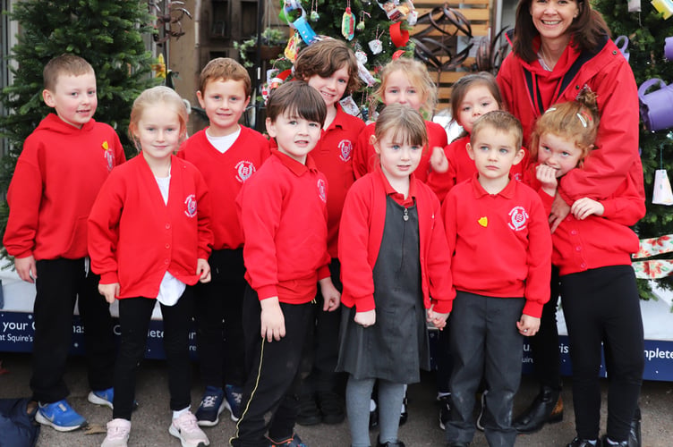 Children from Badshot Lea Village Infant School in front of their winning tree with headteacher Gemma Ball
