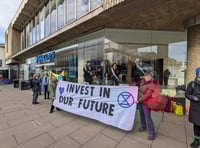 Extinction Rebellion ‘suffragettes’ chain themselves in Guildford bank