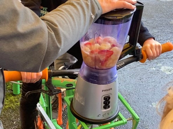 Clara Page rides the smoothie bike at Haslemere's Great Green Get Together