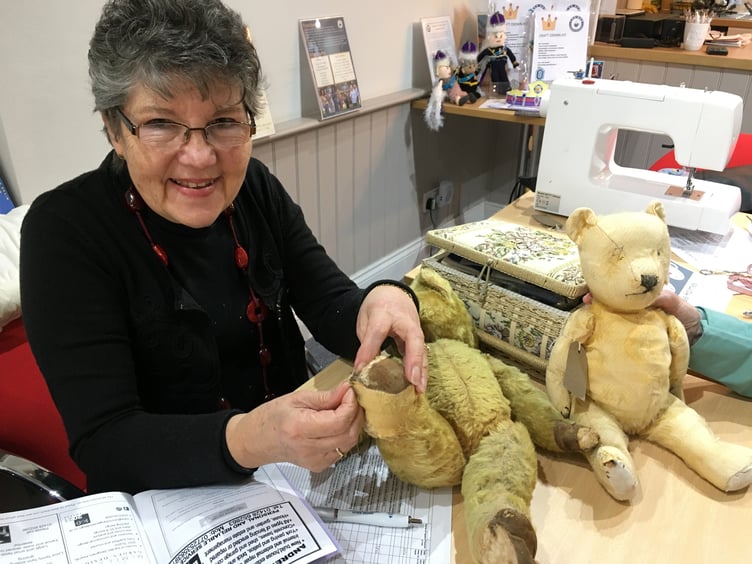 Seamstress Veronica Correa fixing a teddy with four poorly paws at Fernhurst Hub's first repair cafe