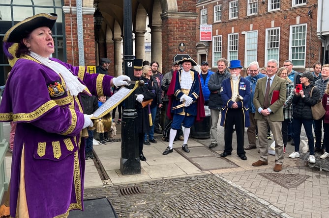 The lady town crier of Bognor Regis, Jane Smith, shows the competitors how it’s done as she addresses the assembled crowd in Castle Street