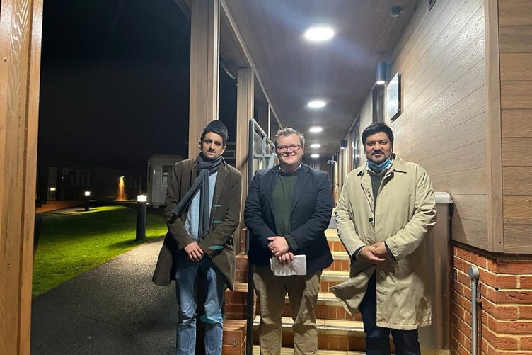 Herald reporter Daniel Gee (centre) with his hosts Atif Rashid and Abrar Ahmad Baig