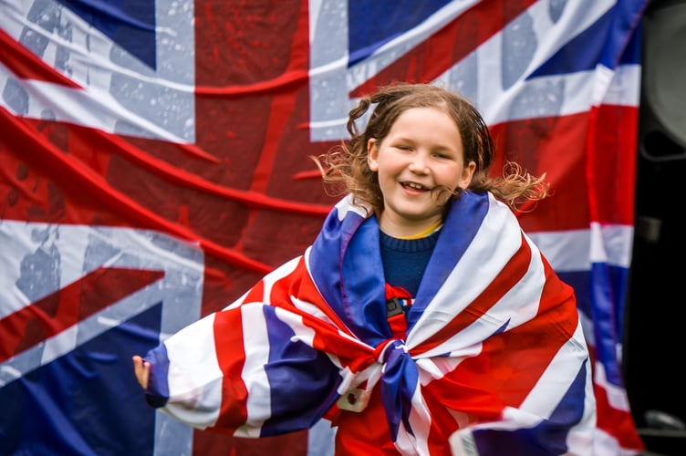 Hundreds braved the rain to attend Farnham's Coronation Day party at Gostrey Meadow on Saturday, May 6