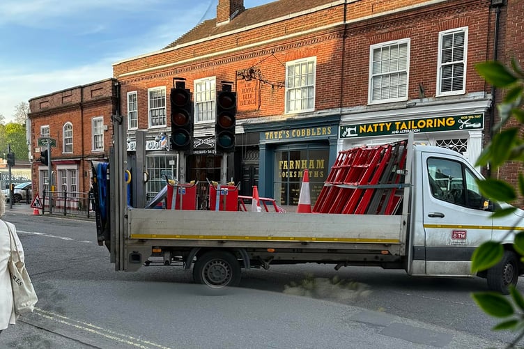 The view from Veena's Kitchen in South Street as Surrey highways workers block off the road for emergency pothole repairs – trapping many motorists in the town centre