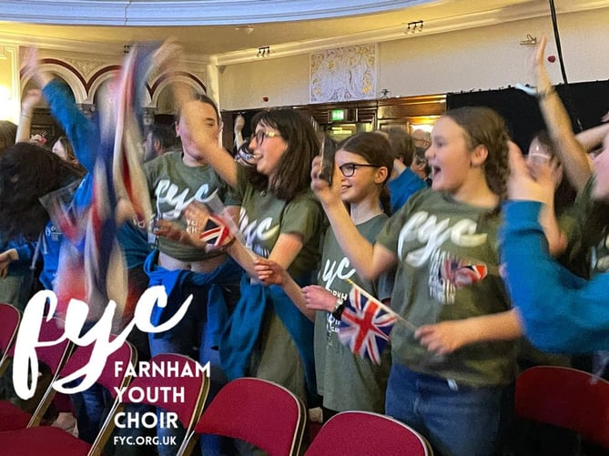 Farnham Youth Choir singers celebrating winning a gold trophy in Hull