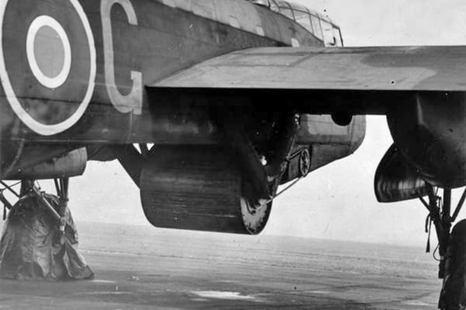 'Upkeep bouncing bomb mounted under Guy Gibson's Lancaster B III (Special) in preparation for Operation Chastise, the 'Dam Dusters' raid