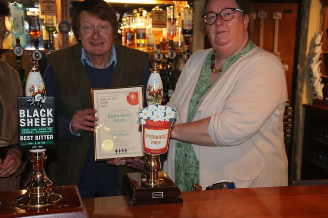 East Hants CAMRA branch chair Julie Nicholson gives its Pub of the Year award to Phil Troubridge, landlord of the Eight Bells in Church Street, Alton, May 3rd 2023.