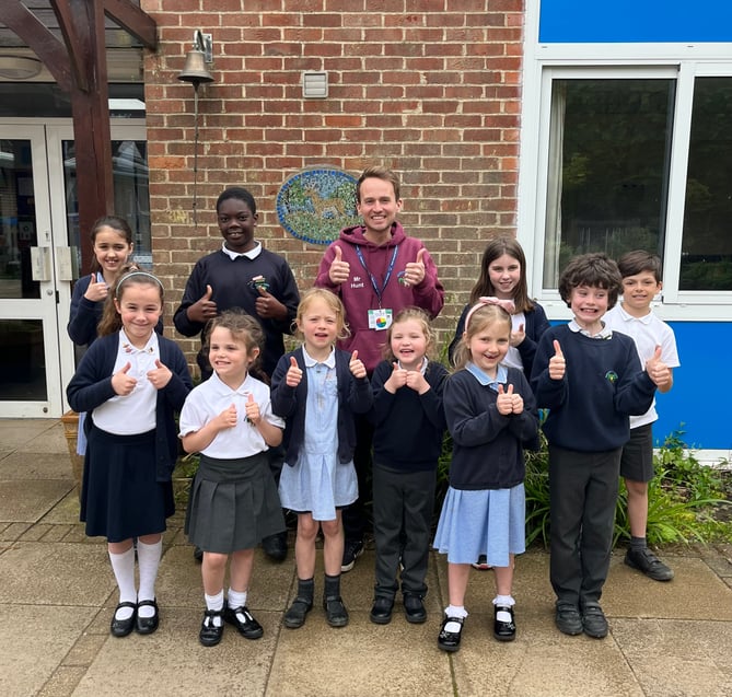 Medstead CE Primary School pupils and staff give a thumbs up to their 'good' Ofsted report, May 2023.