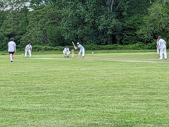 Bharat Katta hits a big six over mid-wicket to reach his century for Petersfield’s second team against Purbrook’s third team