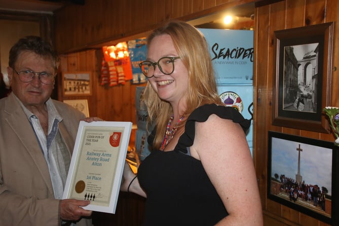 East Hants CAMRA branch secretary Tony Davis presents its Cider Pub of the Year prize to Chloe Watson, May 2023.