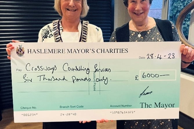 Haslemere's outgoing mayor Cllr Jacquie Keen hands over a cheque for £6,000 to Crossways Counselling Services
