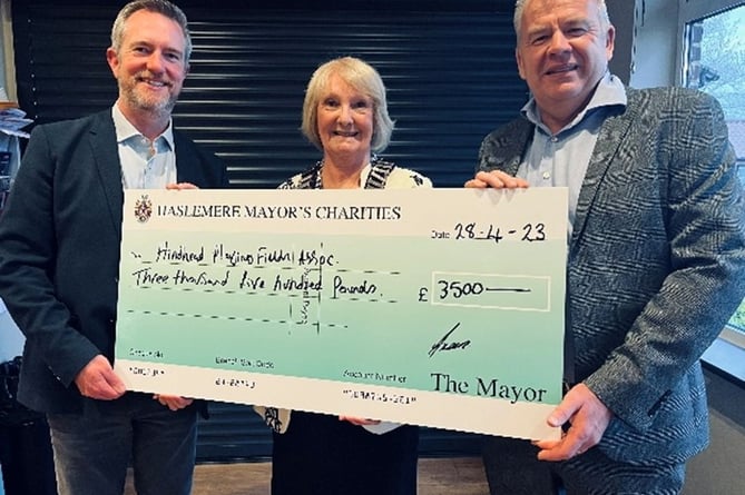 Haslemere's outgoing mayor Cllr Jacquie Keen hands over a £3,500 cheque to Hindhead Playing Fields towards its pavilion