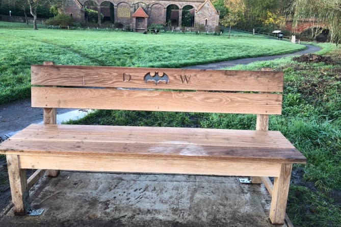 Andy Wyatt is continuing his husband Daron Wyatt's legacy with a bench in Godalming with the Batman symbol engraved on the back