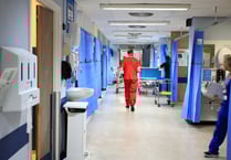 The Royal Surrey County Hospital staff took fewer sick days in December than a year before – as absences across England spike