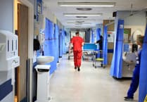 The Royal Surrey County Hospital staff took fewer sick days in December than a year before – as absences across England spike