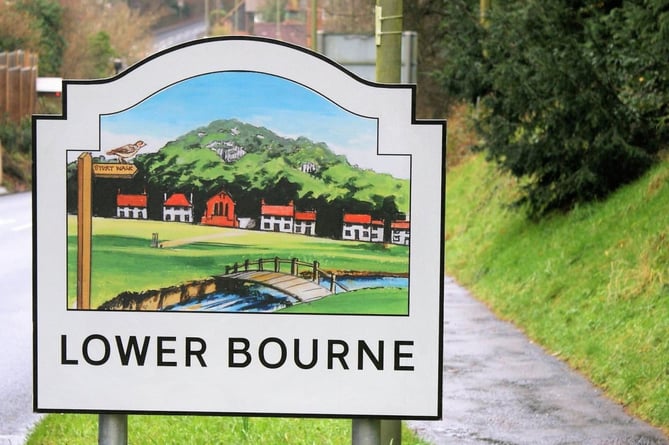 A village entry sign for Lower Bourne