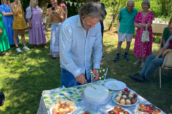 John Bishop cuts the cake to bring his visit to a close