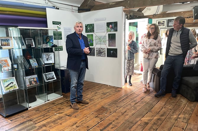 Councillor Mark Merryweather addresses guests at the launch of the North Farnham Art Trail exhibition at Kiln Photo in Badshot Lea
