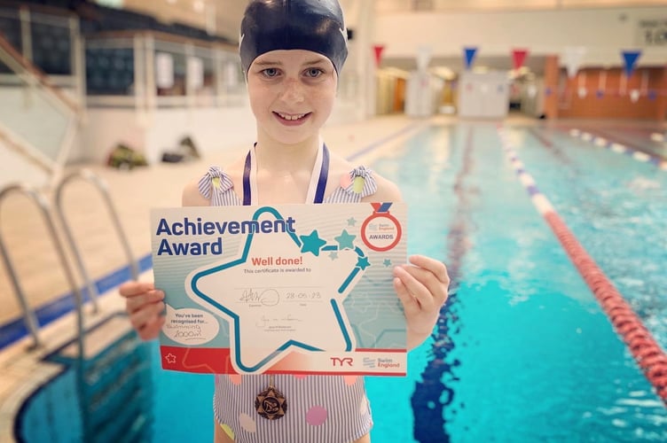 Martha with her certificate after completing her 2km charity swim