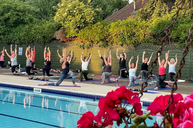 Yogis salute the sun at Petersfield Open Air Swimming Pool – sessions are run regularly by Wild Nest Yoga Studio