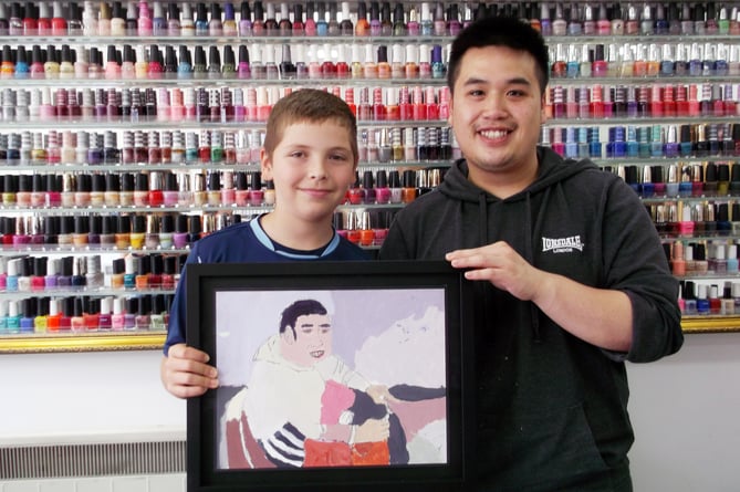 Mylo Acevedo-Scott with his portrait of Tom Luu from VIP Nails in Petersfield