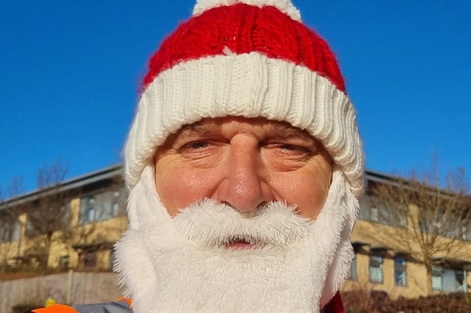 Postie Mark Wheeler dons a Santa beard for his Christmas rounds