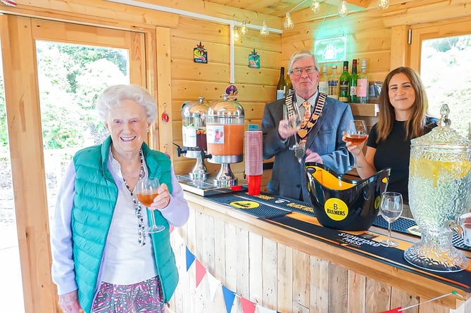  Resident Joyce Douglas enjoying The Redcot Arms’ first drink, served by town mayor Jerome Davidson