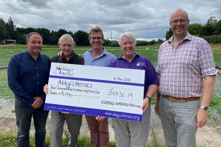 Alresford Watercress Festival donation to Abby's Heroes, July 12th 2023. From left: Simon Lawes, John Cattle, Tom Amery, Sally Randall and Simon Evans.