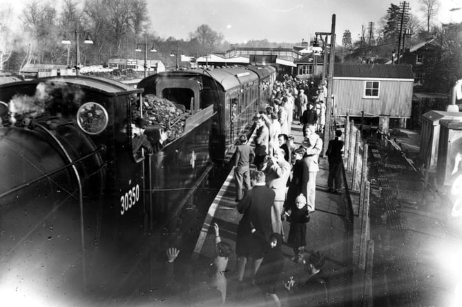 Locomotive Drummond 0-6-0 30350 pauses at Haslemere station on its way to celebrate the 100th anniversary of the 'Gosport Direct' line in 1959