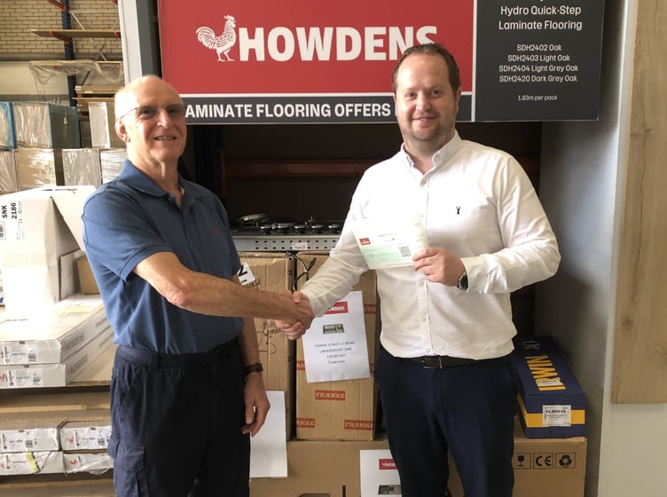 Alton Men's Shed chairman Gordon Anderson is presented with a cheque by Howdens branch manager Andy Barnes, July 25th 2023.