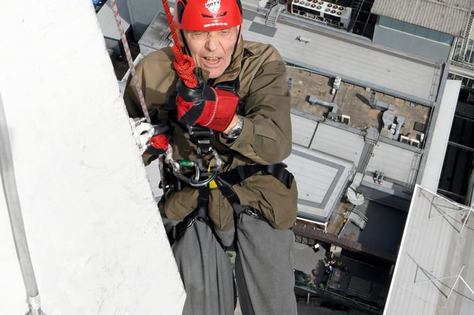 PETER WALKER SPINNAKER ABSEIL 

SPINNAKER TOWER, PORTSMOUTH, HAMPSHIRE
ENGLAND
AUGUST 2023

A 92-year-old Hampshire man undertook a charity abseil in memory of his journalist son who died in March of this year   
Hampshire's Peter Walker navigated his way down Portsmouthâs Spinnaker Tower accompanied by a professional abseiler to honour his son Jon who for many years had been the Chief Reporter at the Petersfield Post, Jon, who was 64, died just weeks after being diagnosed with terminal cancer

The Spinnaker Tower, known as 'The Sail of The Solent' is a 170 metre high observation overlooking the redevelopment of Portsmouth Harbour and the Gunwharf Quays retail complex below as well as offering a 'bird's eye view' of the adjoining Naval Base and across The Solent to the Isle of Wight 

During the summer months many people raise money for charities by experiencing the 100 metre descent and its associated adrenaline rush, but not many are 92 years of age ! 

Mr Walker Senior is aiming to raise money for Fitzroy, a charity often covered by his son which provides a range of services for adults with learning disability, autism and similar conditions.  Mr Walker, who is partially disabled and needed his doctorâs approval to undertake the challenge, said âMy son Jon was a legend because he loved Petersfield and its people and worked hard for them, for me, he is an inspiration....''I am self-sponsoring an abseil from the Spinnaker Tower to raise funds for, and to raise the profile of Fitzroy ''

Peter.....don't look down ! 

(Photo by Malcolm Wells)
 
Standard reproduction rates apply, contact Malcolm Wells to arrange payment - Mobile: 07802-217-569 
malcolmrichardwells@gmail.com
