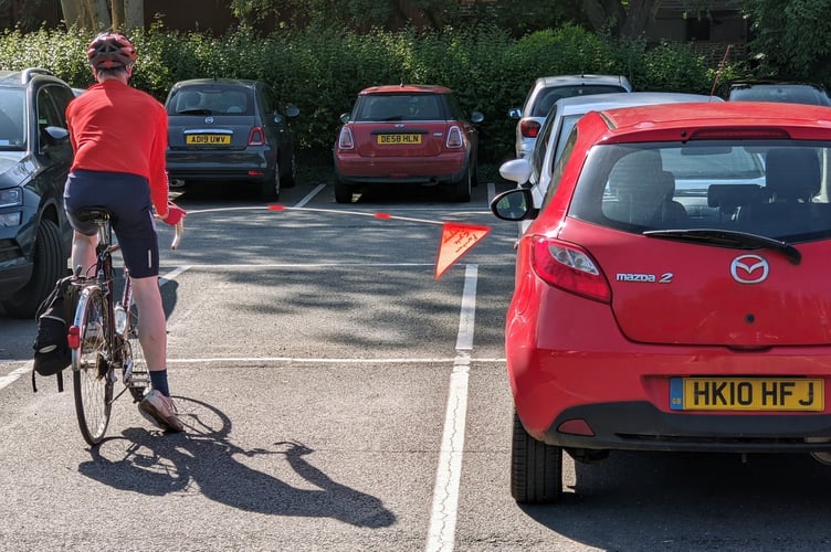 A Farnham U3A member demonstrates the 1.5m width for passing a bike