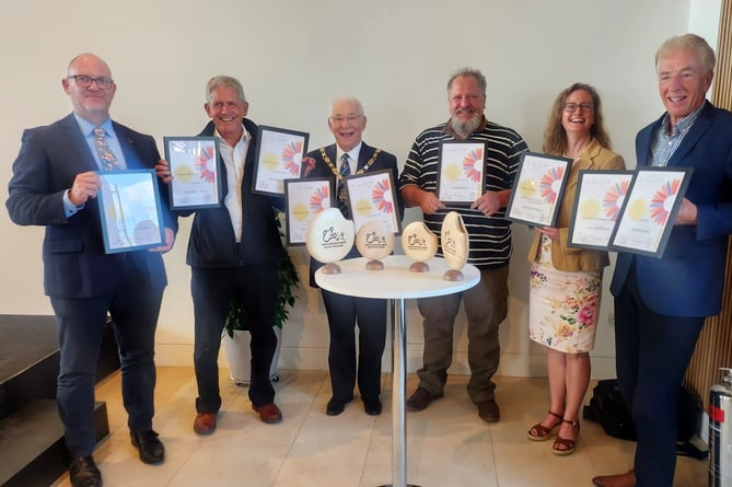 Town mayor Alan Earwaker and other Farnham Town Council representatives show off their best-ever haul of In Bloom awards at RHS Wisley