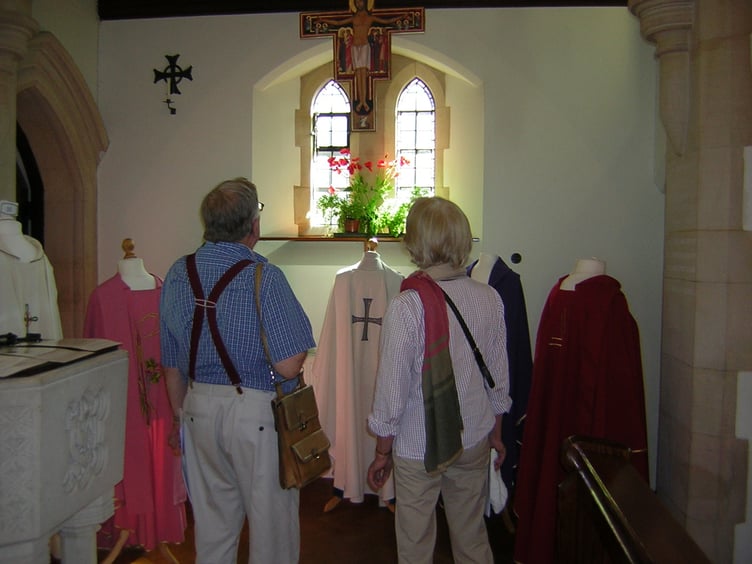 Visitors inspect the priest’s vestments on show at Our Lady of Lourdes Church in Haslemere